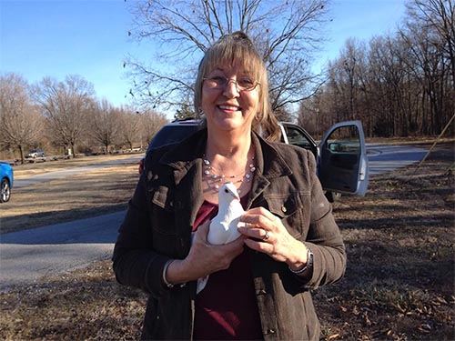 Julie holding a white dove